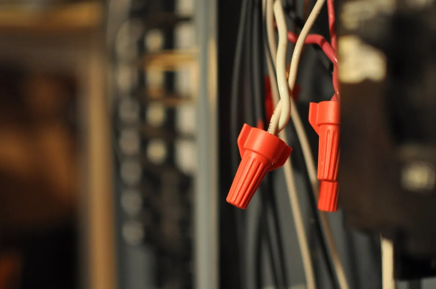 Close-up of new wires joined with orange wire nuts